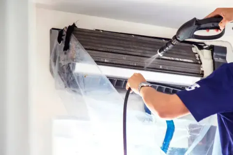 AC unit being serviced on a rooftop in Dubai