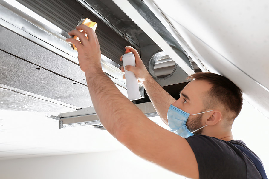 Technician cleaning air ducts in a Dubai apartment